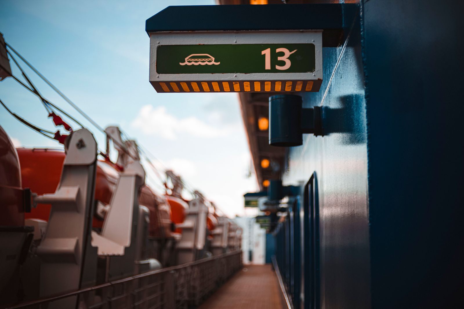 A deck number sign above the lifeboat walkway of a ship, where an inside cabin cruise starts